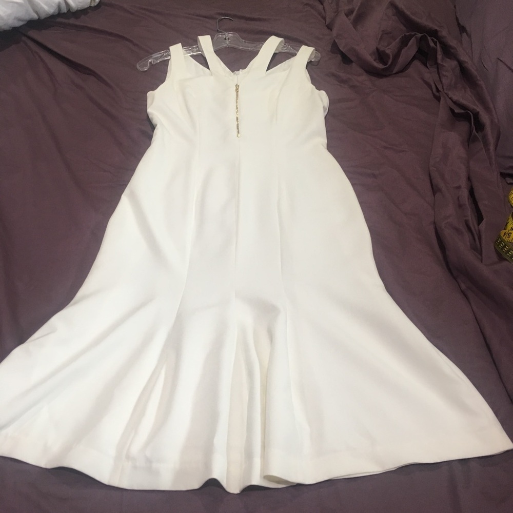 Ivory trumpet fit dress with gold hardware.